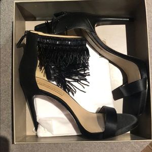 Black BCBG stilettos with fringed ankle strap.